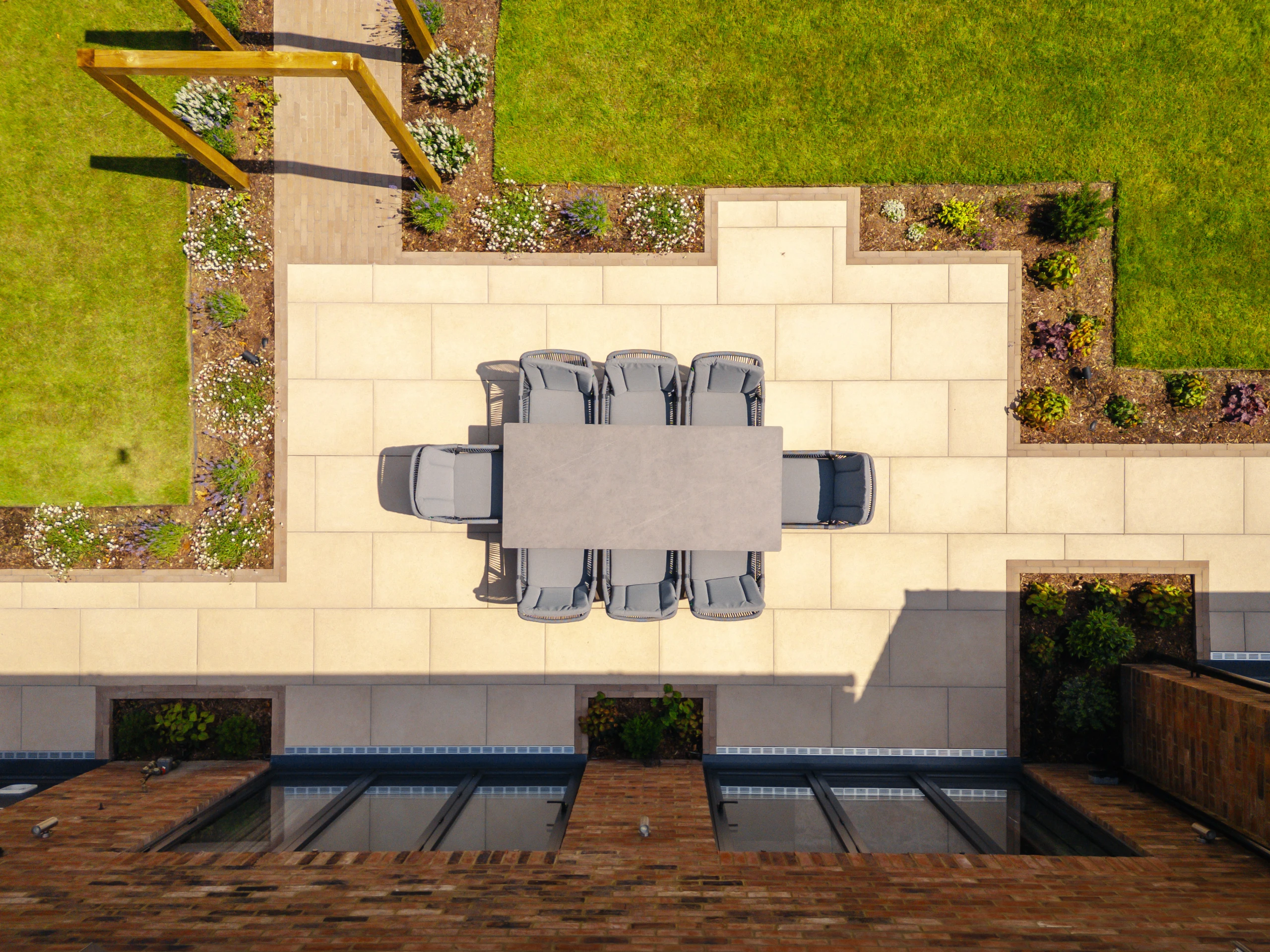 Image shows a bird's eye view of a garden dining area